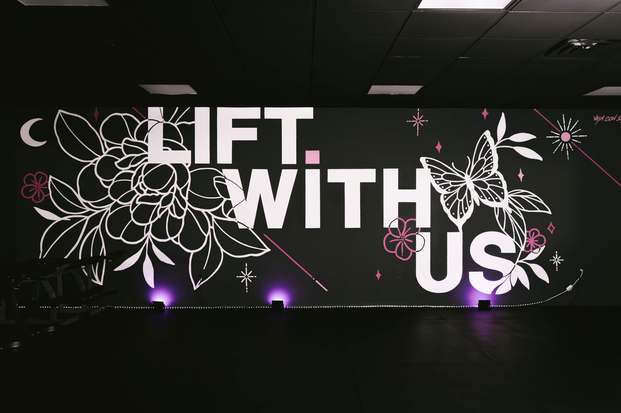 The hand-painted Lift With Us mural in the studio